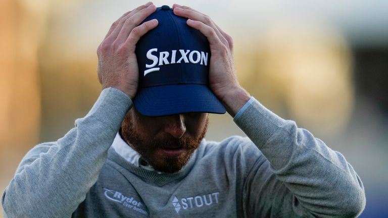 Sam Ryder adjusts his hat after finishing on the 18th hole of the South Course at Torrey Pines during the third round of the Farmers Insurance Open golf tournament, Friday, Jan. 27, 2023, in San Diego. (AP Photo/Gregory Bull)