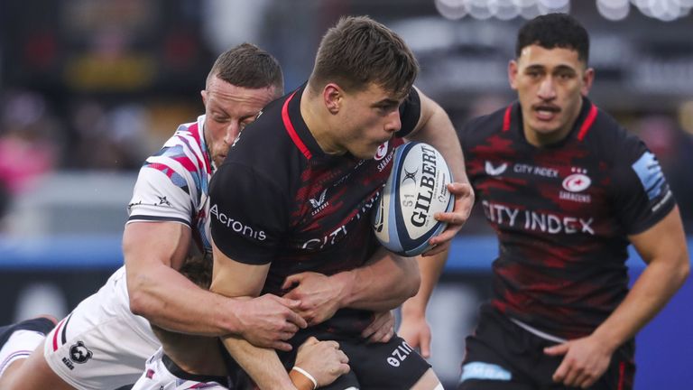 Saracens' Theo Dan is tackled by Bristol's James Williams and Max Lahiff during the Gallagher Premiership match at the StoneX Stadium