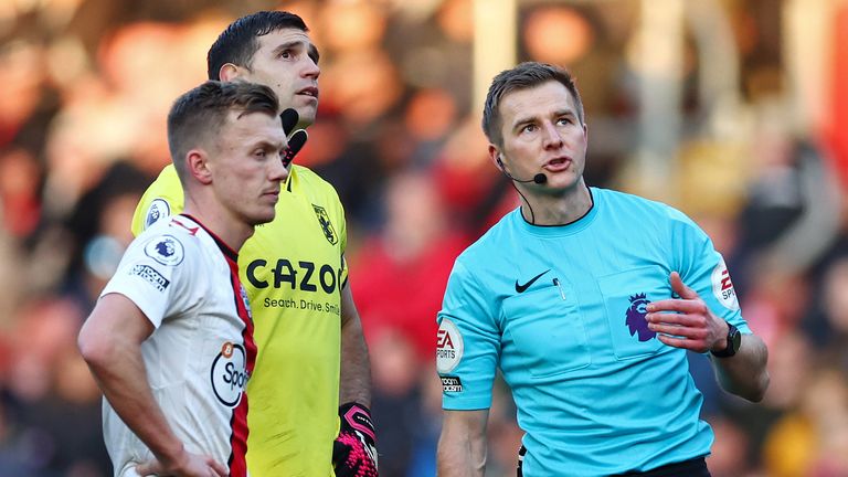 Referee Michael Salisbury reacts after pausing the game due to a drone flying above the stadium