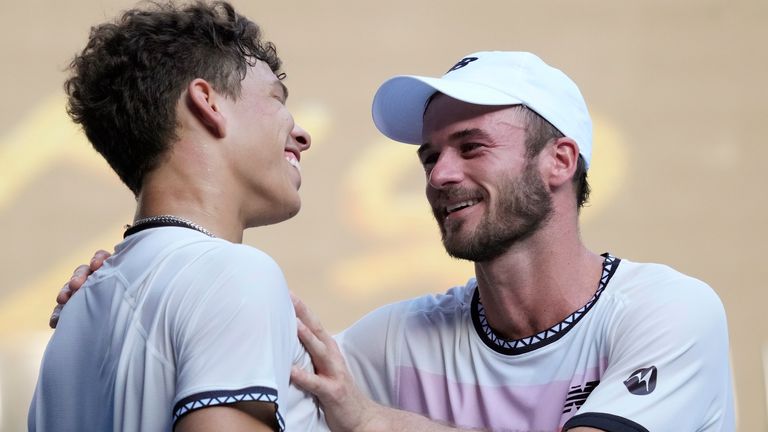 Tommy Paul of the United States, right, is congratulated by compatriot Ben Shelton after their quarter-final match at the Australian Open, Wednesday, Jan. 25, 2023.  (AP Photo/Dita Alangkara) 