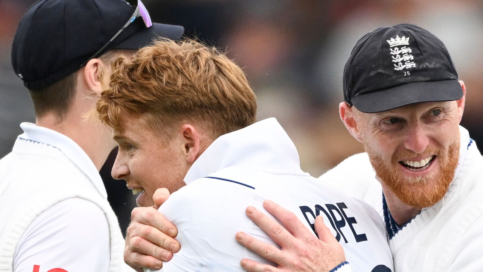 Ollie Pope of England is hugged by captain Ben <b>Stokes</b>, right