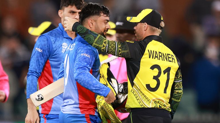 Australia's David Warner, right, embraces Afghanistan's Rashid Khan following their T20 World Cup cricket match in Adelaide, Australia, Friday, Nov. 4, 2022. (AP Photo/James Elsby)