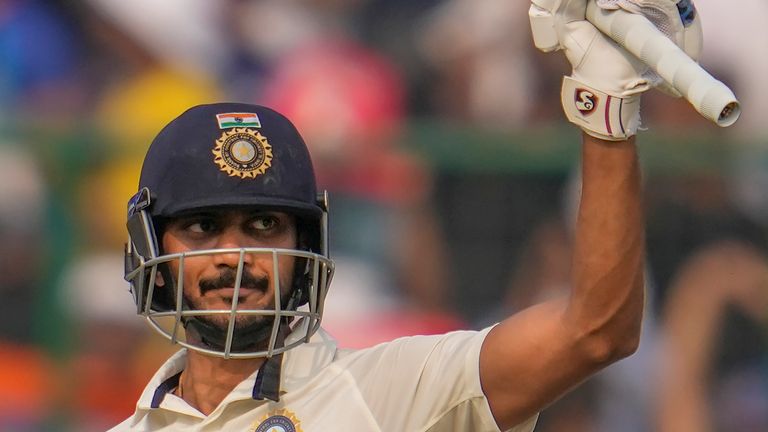 India's Axar Patel raises his bat to celebrate scoring a half century during the second day of the second cricket test match between India and Australia in New Delhi, India,  Saturday, Feb. 18, 2023. (AP Photo/Altaf Qadri)