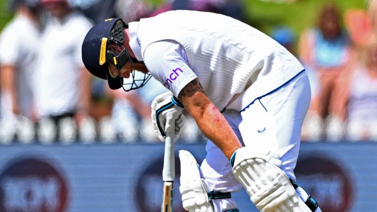 England's Ben Stokes favors his left leg after he appears to be injured while batting against New Zealand on day 5 of their cricket test match in Wellington, New Zealand, Tuesday, Feb 28, 2023. (Andrew Cornaga/Photosport via AP)