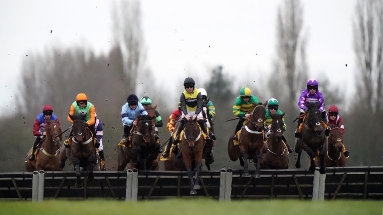 Aucunrisque (yellow and black) jumps to the front at Newbury