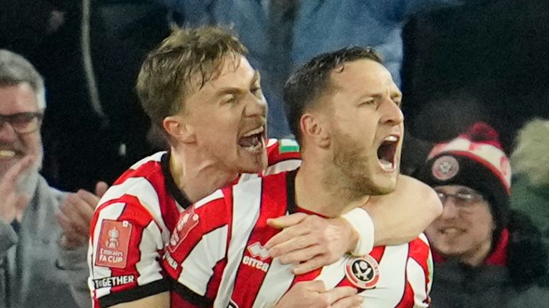 Sheffield's Billy Sharp, centre, celebrates after scoring his side's second goal during the FA Cup 4th round soccer match between Sheffield United and Wrexham at the Bramall Lane stadium in Sheffield, England, Tuesday, Feb. 7, 2023. (AP Photo/Jon Super)