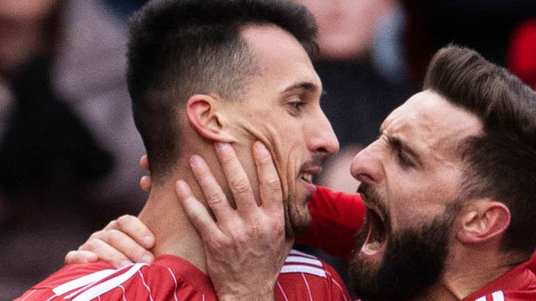ABERDEEN, SCOTLAND - FEBRUARY 25: Bojan Miovski celebrates making it 1-0 with Graeme Shinnie during a cinch Premiership match between Aberdeen and Livingston at Pittodrie Stadium, on February 25, in Aberdeen, Scotland.  (Photo by Ross Parker / SNS Group)