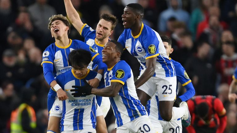 Kaoru Mitoma is mobbed by his team-mates after scoring a late winner for Brighton against Bournemouth