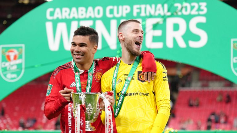 Manchester United's Casemiro and David de Gea pose with the trophy after the Carabao Cup final