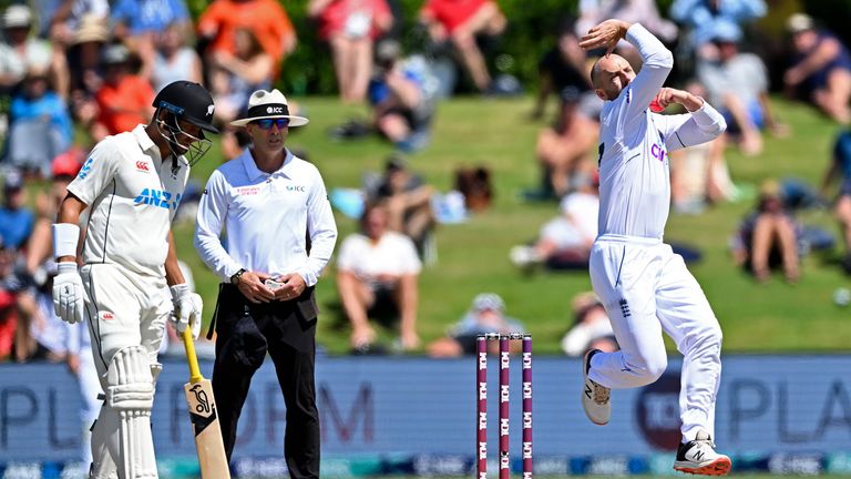 England&#39;s Jack Leach, right, bowls to New Zealand on the fourth day of their cricket test match in Tauranga, New Zealand, Sunday, Feb. 19, 2023. (Andrew Cornaga/Photosport via AP)