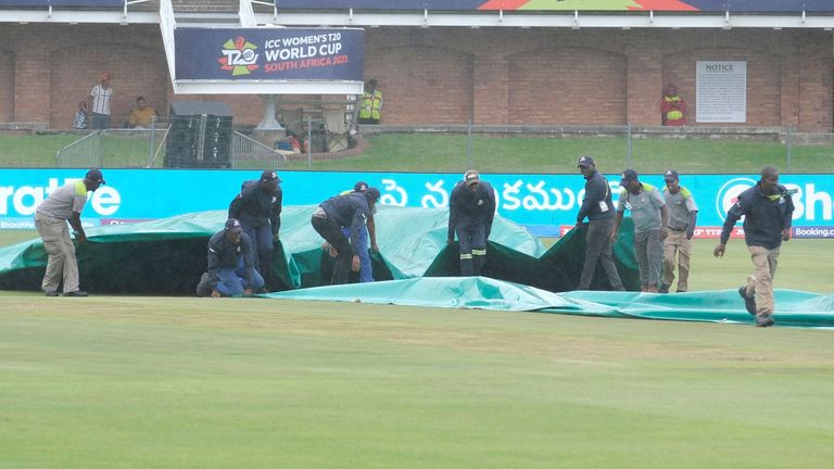 Ground staff protect the crease as rains stops the Group B T20 women's World Cup cricket match between India and Ireland at St George's Park in Gqeberha on February 20, 2023. (Photo by Michael Sheehan / AFP) (Photo by MICHAEL SHEEHAN/AFP via Getty Images)
