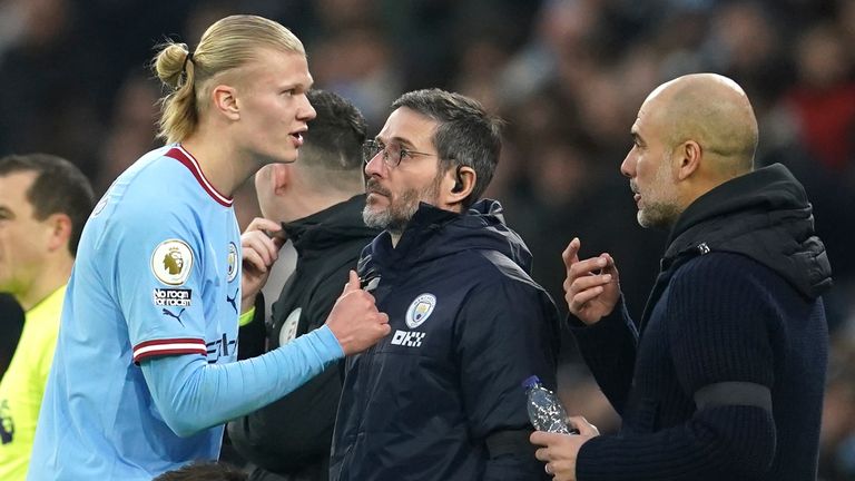 Erling Haaland talks with Pep Guardiola during the first half