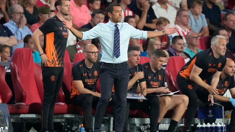 Rangers' coach Giovanni Van Bronckhorst, center, reacts afte Rangers' Antonio Colak scored his side's first goal during a Champions League playoff second leg soccer match between PSV Eindhoven and Rangers, at the Philips stadium in Eindhoven, Netherlands, Wednesday, Aug. 24, 2022. (AP Photo/Peter Dejong)