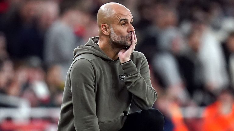 Pep Guardiola looks on at the Emirates Stadium touchline