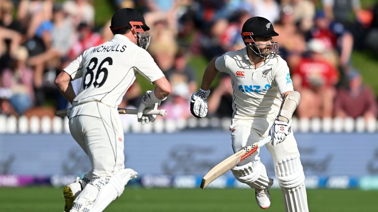 Henry Nicholls, left, and Kane Williamson of New Zealand run between the wickets while batting on day three of the second cricket test between England and New Zealand at the Basin Reserve in Wellington, New Zealand, Sunday, Feb. 26, 2023. (Andrew Cornaga/Photosport via AP)
