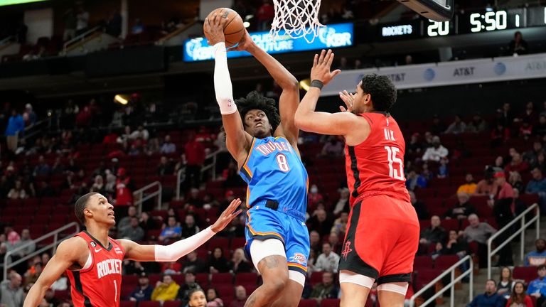Oklahoma City Thunder forward Jalen Williams drives to the basket as Houston Rockets guard Daishen Nix and forward Jabari Smith Jr defend