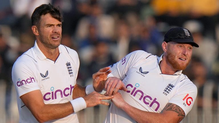 England's James Anderson, center, and Ben Stokes celebrate after the dismissal of Pakistan's Zahid Mahmood during the fifth day of the first test cricket match between Pakistan and England, in Rawalpindi, Pakistan, Monday, Dec. 5, 2022. (AP Photo/Anjum Naveed) 
