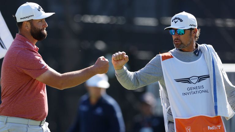 Jon Rahm, right, bumps fists with his caddie after a birdie putt on the 14th hole during the final round of the Genesis Invitational golf tournament at Riviera Country Club, Sunday, Feb. 19, 2023, in the Pacific Palisades area of Los Angeles. (AP Photo/Ryan Kang)
