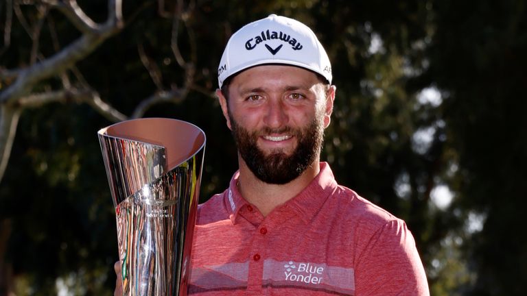 Jon Rahm hold the winner's trophy after winning the Genesis Invitational 