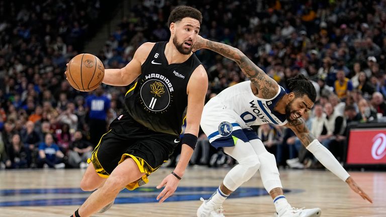 Golden State Warriors guard Klay Thompson works towards the basket while defended by Minnesota Timberwolves guard D&#39;Angelo Russell