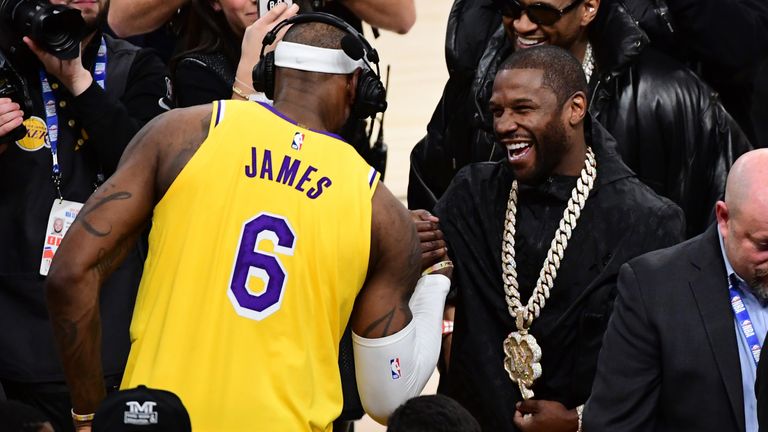 LeBron James is congratulated by Floyd Mayweather Jr after breaking Kareem Abdul-Jabbar's all-time scoring record