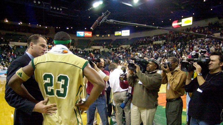 Cameras crowd around LeBron James after he scored 31 points in a 65-45 win over Virginia's Oak Hill Academy Thursday, Dec. 12, 2002 