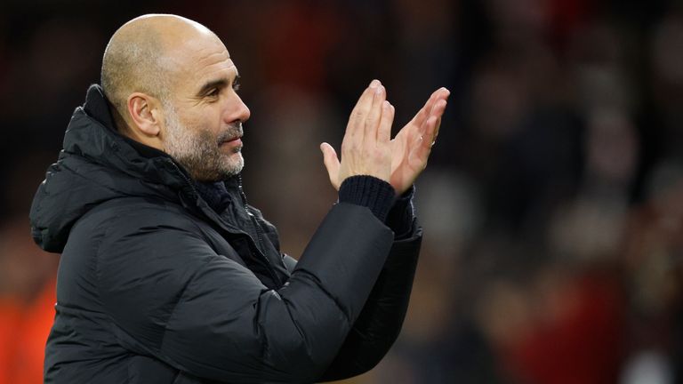 City's head coach Pep Guardiola applauds his fans