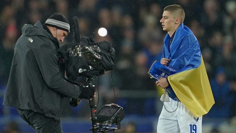 Vitalii Mykolenko enters the pitch for Everton wearing the Ukrainian flag in March 2022
