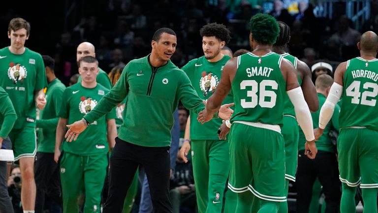 Boston Celtics interim head coach Joe Mazzulla, center, celebrates with guard Marcus Smart.