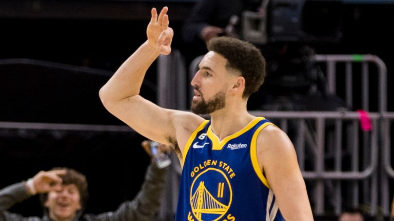 Golden State Warriors guard Klay Thompson (11) reacts after hitting a three-point shot against the Oklahoma City Thunder during the second half of an NBA game.