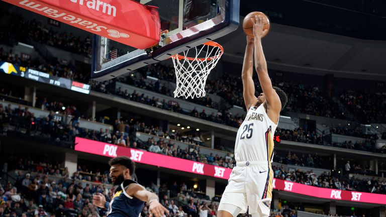 New Orleans Pelicans guard Trey Murphy III, right, goes up for a basket as Denver Nuggets guard Jamal Murray defends in the second half of an NBA basketball game.