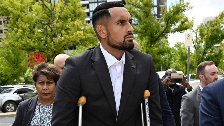 Australian tennis player Nick Kyrgios, center, arrives at the ACT Magistrates Court in Canberra, Friday, Feb. 3, 2023. Kyrgios has pleaded guilty in an Australian court to assaulting a former girlfriend during an argument in January 2021. (Mick Tsikas/AAP Image via AP)
