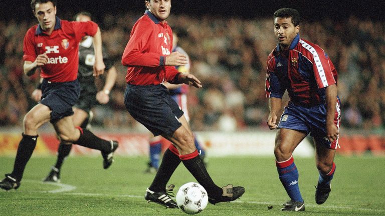 Barcelona's Brazilian striker Romario (r) gets the better of Jose Mari Garcia of Osasuna in a first division soccer match on Saturday, Feb. 19, 1994 in Barcelona. Romario went on to score three goals as Barcelona hit form in an impressive 8-1 victory. 