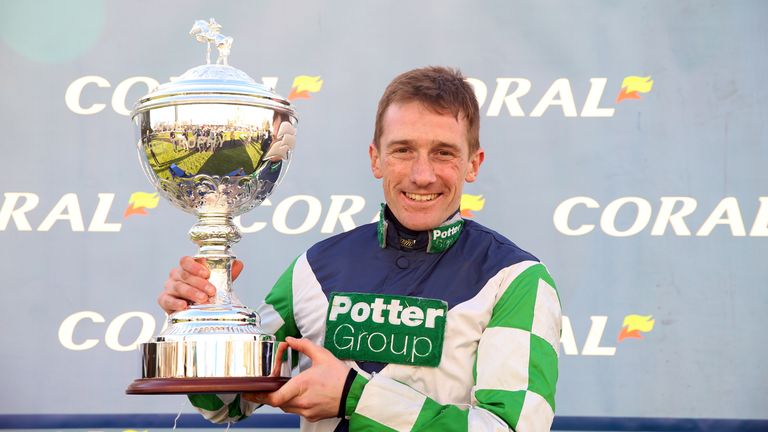 Sam Twiston-Davies poses for the cameras with the Coral Trophy