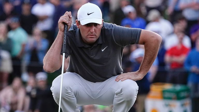 Scottie Scheffler reads a putt on the 18th hole during the third round of the Phoenix Open golf tournament, Saturday, Feb. 11, 2023, in Scottsdale, Ariz. Scheffler leads the tournament at 13 under par. (AP Photo/Darryl Webb)