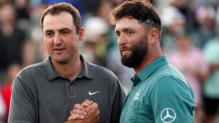 Scottie Scheffler, left, and Jon Rahm, right, congratulates each other after their third round of the Phoenix Open golf tournament, Saturday, Feb. 11, 2023, in Scottsdale, Ariz. (AP Photo/Darryl Webb)