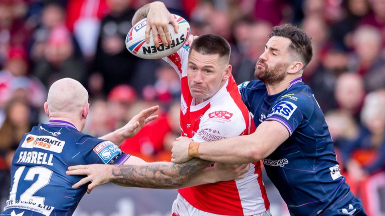 Picture by Allan McKenzie/SWpix.com - 18/02/2023 - Rugby League - Betfred Super League Round 1 - Hull KR v Wigan Warriors - Sewell Group Craven Park, Hull, England - Hull KR&#39;s Shaun Kenny-Dowall is tackled by Wigan&#39;s Liam Farrell & Toby King.