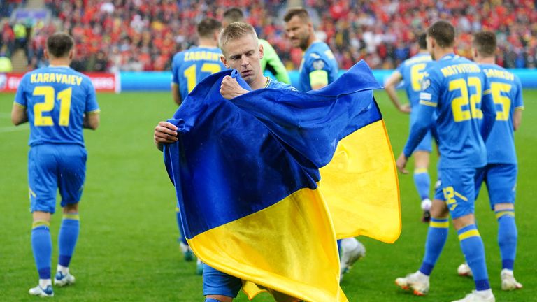 Ukraine captain Oleksandr Zinchenko holding the Ukranian flag before a World Cup qualifier against Wales in June