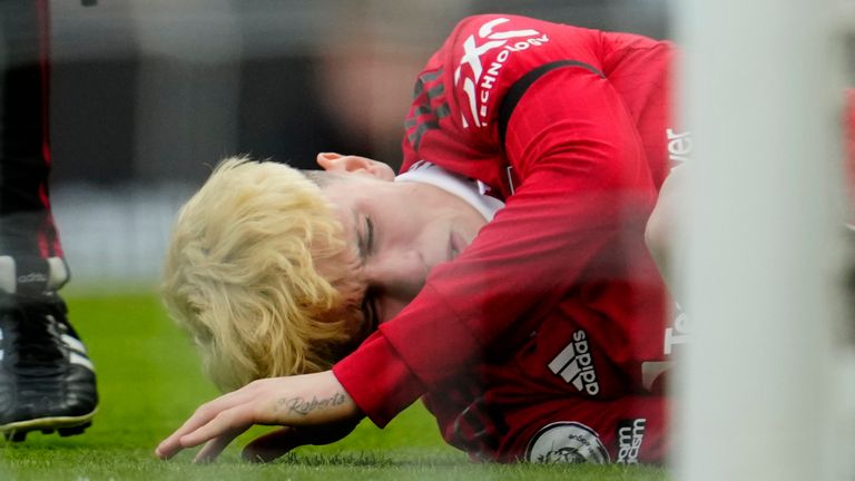 Manchester United's Alejandro Garnacho receives medical attention during the English Premier League soccer match between Manchester United and Southampton at Old Trafford stadium in Manchester, England, Sunday, March 12, 2023. (AP Photo/Jon Super)