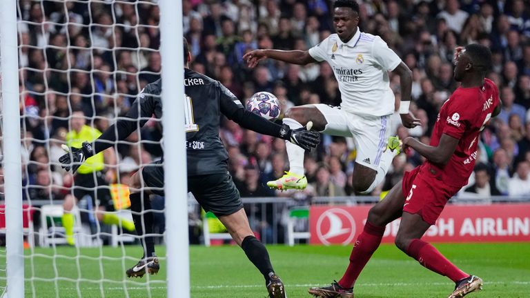 Real Madrid's Vinicius Junior, centre, tries to beat Liverpool's goalkeeper Alisson during the Champions League, round of 16 second leg soccer match between Real Madrid and Liverpool at the Santiago Bernabeu stadium in Wednesday, March 15, 2023. (AP Photo/Manu Fernandez)