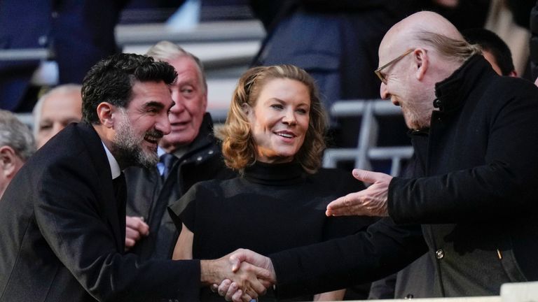 Manchester United's Chairman Avie Glazer, right, and Newcastle United's Chairman Yasir Al-Rumayyan, left, shake hands and Newcastle's Club Director Amanda Staveley, centre, smiles before English League Cup final soccer match between Manchester United and Newcastle United at Wembley Stadium in London, Sunday, Feb. 26, 2023. (AP Photo/Alastair Grant)