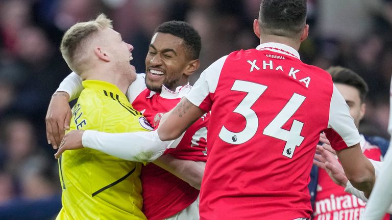 Reiss Nelson is mobbed by his team-mates after scoring a late winner for Arsenal
