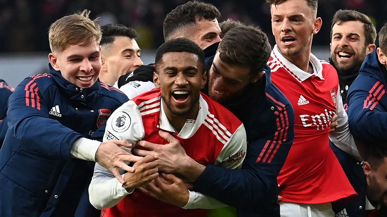 Reiss Nelson is mobbed by team-mates after his late strike completes Arsenal's fightback against Bournemouth