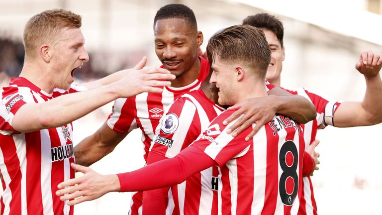 Mathias Jensen is mobbed by his team-mates after scoring Brentford's opener against Leicester