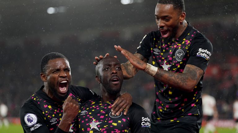 Yoane Wisse celebrates with teammates after putting Brentford 2-0 up in stoppage time
