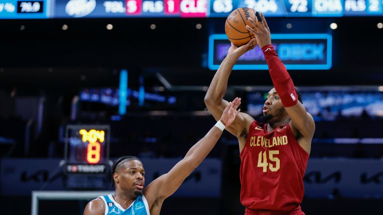 Cleveland Cavaliers guard Donovan Mitchell (45) shoots over Charlotte Hornets guard Dennis Smith Jr. 