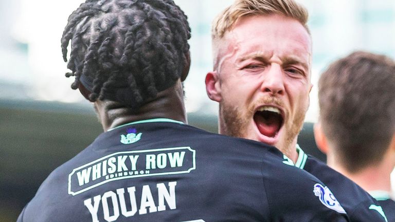 LIVINGSTON, SCOTLAND - MARCH 04: Hibernian's Elie Youan celebrates with James Jeggo after scoring to make it 2-1 during a cinch Premiership match between Livingston and Hibernian at the Tony Macaroni Arena, on March 04, 2023, in Livingston, Scotland. (Photo by Roddy Scott / SNS Group).