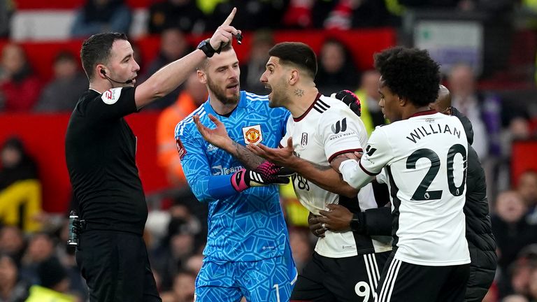 Aleksandar Mitrovic is contained after his sending off at Old Trafford