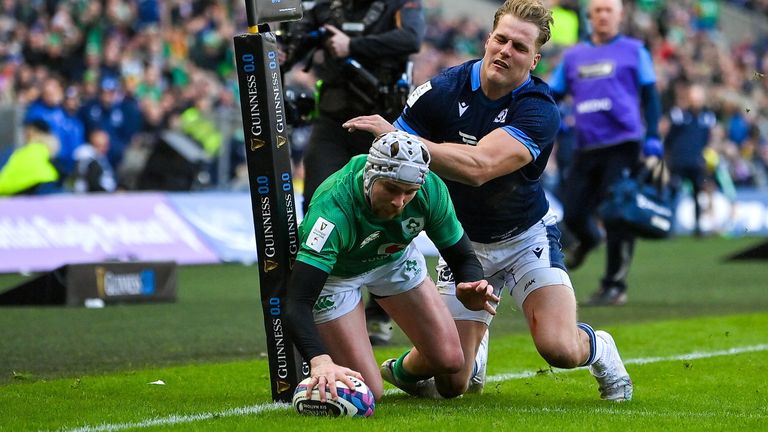 12 March 2023; Mack Hansen of Ireland scores his side's first try despite the tackle of Duhan van der Merwe of Scotland during the Guinness Six Nations Rugby Championship match between Scotland and Ireland at BT Murrayfield Stadium in Edinburgh, Scotland. Photo by Brendan Moran/Sportsfile
