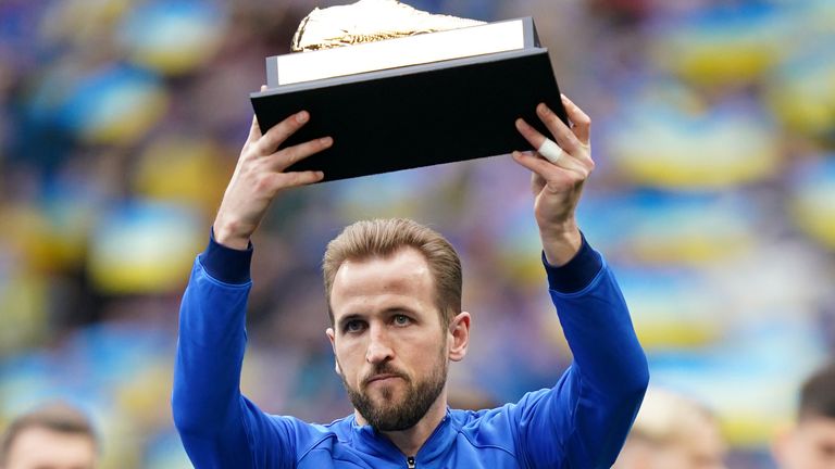 Harry Kane holds up a golden boot presented to him for becoming England&#39;s all-time record goalscorer
